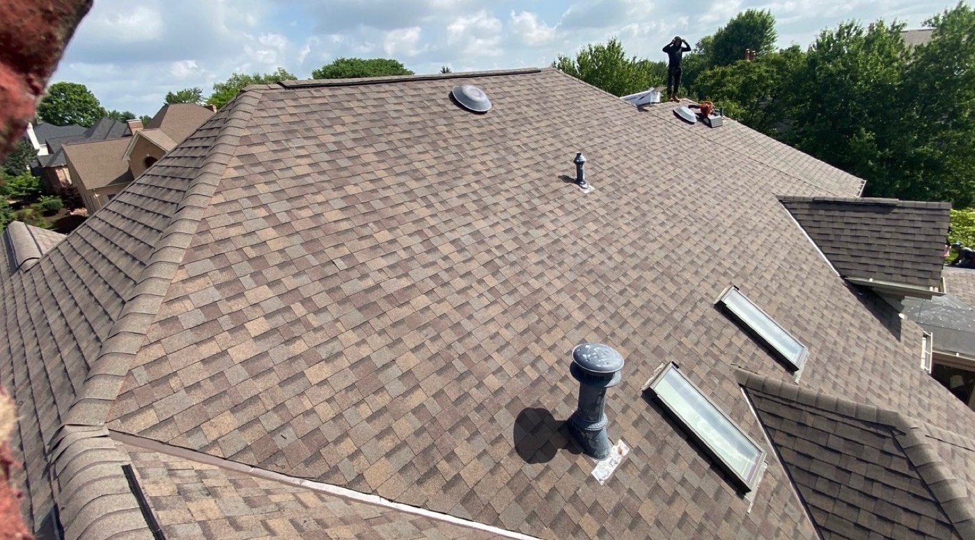Drone view of a large brown blend shingle roof replacement