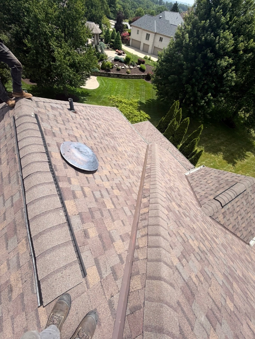 New brown blend shingles with low-profile attic vent and skylights