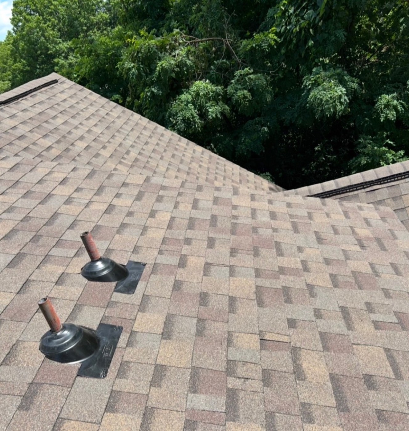 New brown blend shingles with sealed pipe boot flashings